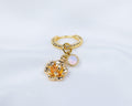 Handgemaakte 14k gold plated gedraaide oorbel met hanger in de vorm van een narcis bloem en opaal roze zirkonia steen