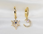 Set van twee handgemaakte 14k gold plated oorbellen met een maan en ster hanger van witte, roze en blauwe zirkonia
